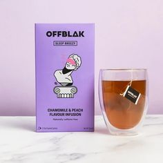 a cup of tea next to a box of offblaak