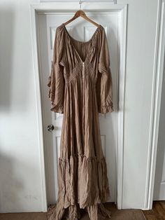 Plus Size Tan color linen gauze rental dress. Fits maternity and non-maternity XL-3XL. I will ship to you a few days before your scheduled shoot. You will have rental for 7 days. You are responsible for return shipping.  Not to be worn for an actual event such as a baby shower or wedding.  Lift gown as much as possible while moving around and place down for pictures in order to reduce damage to dress. Please message me to verify that your date is available before placing order.  Add your date in Spring Beach Maternity Dress With Long Sleeves, Spring Maternity Beach Dress With Long Sleeves, Bohemian Linen Dress With Ruffles, Bohemian Maternity Dress For Spring Vacation, Bohemian Linen Maxi Dress With Ruffles, Summer Maternity Dresses With Long Sleeves, Summer Maternity Dress In Beige, Bohemian V-neck Maternity Dress, Summer Beige Maternity Dress