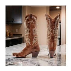 Idyllwind Women's Actin Up Western Boots (Medium Sizes) in a rich brown color. These boots are designed for the modern cowgirl who loves to have fun and make a statement. Featuring a pointed toe, these boots offer a sleek and sophisticated look. The pull tabs make it easy to slip on and off, while the leather upper provides durability and style. The Western stitching on the shaft adds a touch of classic flair, while the Western heel provides a comfortable fit. The single-stitched welt ensures lo Modern Cowgirl, Brown Design, Heel Caps, Cowboy Western, Western Cowboy Boots, Rubber Heels, Salt Lake City, Lake City, Western Boots