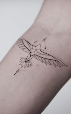 a small bird tattoo on the arm