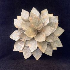 a paper flower made out of old book pages