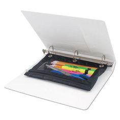 an open binder with pens and pencils in it