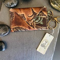 This Boho Style Mini Wallet Will Easily Fit Credit Cards, Business Cards, And Cash. If You're Used To Carrying A Large Wallet And Want To Downsize For Errands Or A Night Out, Then This Little Beauty Should Do The Job! Not Only Is It Unique, It's Made With High-Quality Leather And Whether You Dress It Up Or Down, It's Easy To Keep Things Light. It Measures 4" X 3" And Includes An Attached Key Chain And Clip. You Can Clip It Onto Your Belt Hoop For A Total Hands Free Experience. Coffee In One Hand Handmade Brown Coin Purse For Personal Use, Hand Tooled Brown Wallets As Gift, Artisan Brown Trifold Wallet Gift, Brown Hand Tooled Coin Purse Gift, Brown Hand Tooled Trifold Wallet As Gift, Brown Leather Wallet On Chain With Card Slots, Handmade Brown Coin Purse, Rustic Leather Wallets With Card Slots, Western Style Brown Trifold Wallet With Card Slots