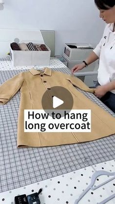 a woman sitting at a table with a shirt on top of it and the words how to hang long overcoat