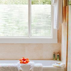 a white bath tub sitting next to a window