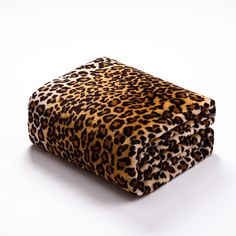 a leopard print blanket sitting on top of a white surface