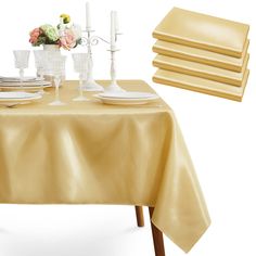 a table set with place settings and flowers