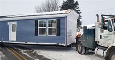 a truck pulling a tiny house on the back of it's trailer