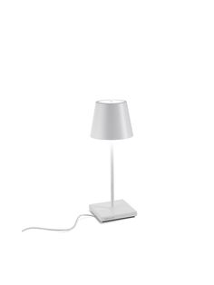 a lamp that is sitting on top of a table next to a remote control in front of it