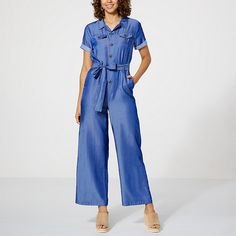 Curations x Sarah Anderson Chambray Denim Belted Utility Jumpsuit  A laid-back look you'll love, this utilitarian-style chambray jumpsuit is comfortably belted in the middle to casually (and flatteringly) define your shape. Pair with sandals and a sun hat for an easy vaca look, or tennies and a ponytail for casual weekend wear. Blue Relaxed Fit Utility Jumpsuit Or Romper, Blue Utility Jumpsuits And Rompers With Relaxed Fit, Blue Relaxed Fit Utility Jumpsuits And Rompers, Casual Solid Belted Jumpsuits And Rompers, Casual Spring Jumpsuits And Rompers With Belted Cuffs, Casual Blue Denim Jumpsuit With Belt Loops, Spring Belted Overall Jumpsuits And Rompers, Blue Utility Jumpsuits And Rompers For Spring, Spring Denim Jumpsuit For Work With Belt Loops