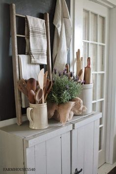 an old ladder is used as a shelf for utensils