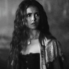 a black and white photo of a woman with long hair