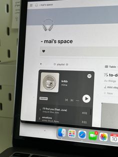 an open laptop computer sitting on top of a desk next to white shelves with magnets