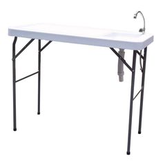 a white sink sitting under a faucet on top of a metal frame table