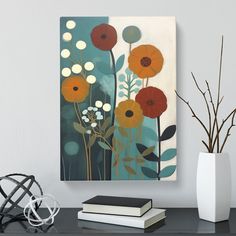 a painting on a wall next to a vase with flowers in it and two books