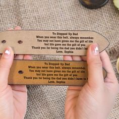 a person holding a leather bookmark with a poem on it