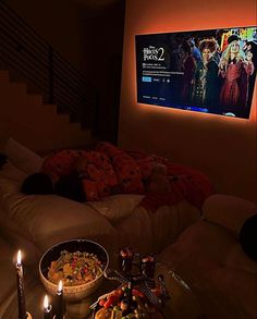 a living room filled with furniture and a flat screen tv mounted to the side of a wall