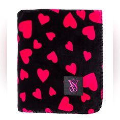 a black and pink blanket with hearts on it