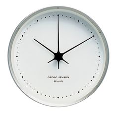 a white clock with black hands and numbers on the face is shown against a white background