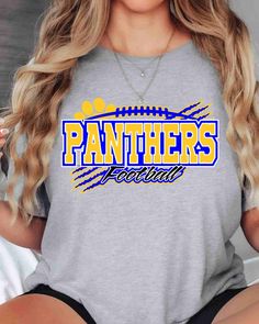 a woman wearing a grey shirt with the word panthers written in blue on it