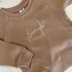 Personalize with any name, or something custom of your own! This lightweight, hand made pullover is made of 100% organic cotton and is perfect for cool summer nights to keep your little one warm. It's just perfect for layering over our classic t-shirts! Cool Summer, Embroidered Tshirt, Kids Tops, Summer Nights, Pullover Sweatshirt, Summer Fun, Hand Embroidered, Classic T Shirts, Knot