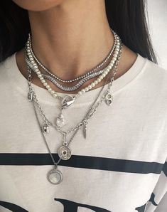 "Explore our stunning necklace collection featuring multi-layered chains with statement pearls, and modern shell pendants - the epitome of timeless elegance and contemporary style. Welcome! 📌Please Kindly Note: It is a set of five layering chain necklaces that have their own clasp, and you can buy them together or separately. 📌The first and second layers are made of stainless steel and zircon stones. 📌The third layer is made of individual glass pearl beads. The clasp is made of zamak, immerse Layered Silver Necklaces Grunge, Pearl Necklace Styling, Silver Layered Necklaces, Pearl Necklace Layering, Layering Chains, Necklaces Pearl, Dope Jewelry Accessories, All Black Fashion, Pearl Statement Necklace