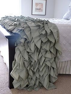 a bed with a ruffled blanket on top of it