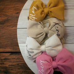 Adorn your precious bundle of joy with our darling hair bows, specially designed for the tiniest cuties. These dainty bows are as sweet as your baby's smile, adding an extra touch of charm to those tiny tufts of hair. Crafted with the softest materials and gentle elastics, they are comfortable and safe for delicate heads. Whether it's a cozy day at home or a special family gathering, our baby hair bows are the perfect accessory to make your little one even more heart-meltingly adorable. A must have baby accessory! Great to pack in hospital bag for babies first photos or to gift! I know how precious and sensitive babies are first hand. I promise this headband will not leave a mark on babies head. Handmade with your little one in mind, as if they were my own! Customizing a personalized headb Adjustable Cream Hair Accessories With Bow, Satin Bow Headband For Gifts, Playful Adjustable Bow Headband, Playful Matching Headband For Playtime, Adjustable White Headband For Playtime, Playful Bow Headband For Gift, Whimsical Adjustable Hair Accessories For Birthdays, Adjustable White Bow With Matching Headband, Whimsical Adjustable Hair Accessories For Birthday