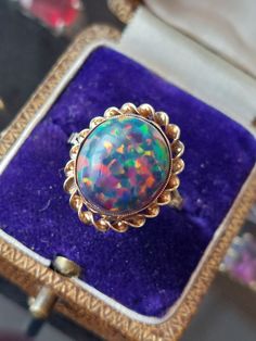 A women's fabulous vintage ring set with a striking Ethiopian fire opal in a solid 9ct gold chunky mount, the ring features fine twisted barley gold work around the setting. The ring is in excellent vintage condition and is fully hallmarked.  The ring may be resized at any accredited jewellers.  Uk size N 1/2 Us size 6.75 EU size 53.5 The gemstones measures 13mmx11mm Weight 3.46g Natural gemstone  Thank you for choosing Carriesclocks  Buying antique and vintage jewellery is both ethical and eco- Vintage Gold Opal Cabochon Ring, Collectible Yellow Gold Opal Ring Oval Cabochon, Vintage Opal Ring As A Gift, Victorian Cabochon Opal Ring For Gift, Victorian Opal Cabochon Ring As Gift, Vintage Opal Ring Collectible, Victorian Style Cabochon Opal Ring Gift, Vintage Opal Cabochon Ring, Collectible Oval Cabochon Opal Ring In Yellow Gold