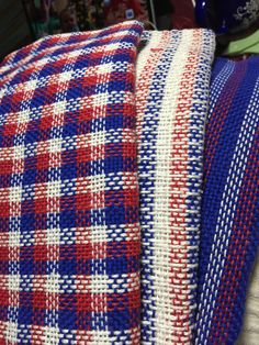 red, white and blue checkered fabric sitting on top of each other