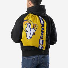 Whether you're going to work, class, or the gym, make sure you always put the team on your back. Literally. Store your stuff and show off your team spirit with this Los Angeles Rams Yellow Alternate Color Big Logo Drawstring Backpack. Features Easy adjustable cinch top cords to make storing your stuff quick and easy Screen printed design so everyone knows who you're rooting for on gameday Details Dimensions: Approximately 18 in. x 14 in. Volume: Approximately 4L Officially licensed Imported Black Bags For Sports With School Spirit Style, Casual Black Gym Bag For Sports Events, Black School Spirit Bag For College, Casual Backpack For Sports Events, Black Drawstring Gym Bag For Sports, Sporty Drawstring Backpack For The Gym, Sporty Gym Backpack With Drawstring, Sports Gym Bag Backpack With Drawstring, Sports Backpack Gym Bag With Drawstring