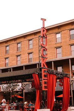 a large red sign that is on the side of a building