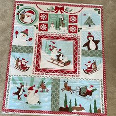 a quilted christmas scene with santa claus and reindeer on sleighs, snowmen, trees, and penguins