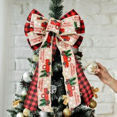 a christmas tree decorated with plaid ribbon and ornaments