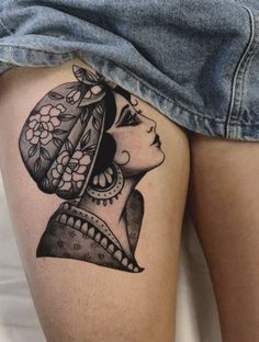 a woman's thigh with a tattoo on it