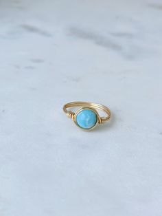 Stunning turquoise and white crackled 7mm Larimar gemstone bead hand-wrapped in gold or silver wire. Ocean-inspired Round Gemstone Bead Jewelry, Adjustable Larimar Turquoise Ring, Adjustable Turquoise Larimar Ring, Handmade Blue Turquoise Larimar Ring, Adjustable Blue Larimar Ring, Ocean Tides, Detail Shop, Hand Wrap, Silver Wire