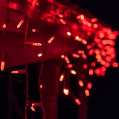 red lights are hanging from the side of a building