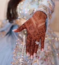 a woman's hand with henna on it