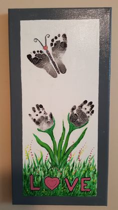 two handprints are displayed on a white background with green grass and pink hearts