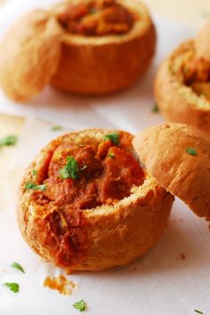 some food is sitting on top of a white tablecloth and it looks like they have been made into muffins