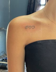 a woman with a heart tattoo on her shoulder