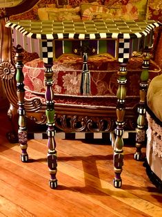 an ornately decorated table in the corner of a room