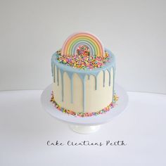 a cake decorated with sprinkles and a rainbow