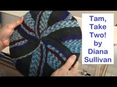 a person holding up a hat with the words tam, take two by diana sulllivan