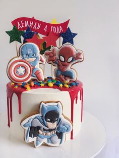 a birthday cake with spiderman and captain america decorations