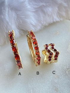 "These red CZ Hoop and Huggie Earrings are 18K Gold Filled. There are three styles available with a lever back closure: A. This is a medium sized hoop with oval reddish CZ stone. The stone color is more true to a fire brick red. dimension: 19mm x 19mm (approximately 3/4\")   B. A medium sized hoop with a round \"brick red\" CZ stone. Diameter: 18mm C. Huggie are a small hoop that hugs the ear lobe when you wear it. This Huggie earring comes with dark red CZ stone. it measures approximately .5\" in diameter and .5\" in height.  Hypoallergenic Nickel Free Water & Sweat Resistant  18K Gold Filled / Oro Laminado 18K" Red Hoop Huggie Earrings, Elegant Red Huggie Hoop Earrings, Small Red Hypoallergenic Hoop Earrings, Red Adjustable Hypoallergenic Hoop Earrings, Red Hypoallergenic Hoop Jewelry, Red Huggie Earrings For Anniversary, Red Hoop Jewelry For Anniversary, Elegant Small Red Hoop Earrings, Elegant Red Small Hoop Earrings