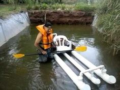 a man in an orange life jacket is using a kayak to move through the water