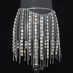 Elevate your style with our stunning Shiny Rhinestone Long Tassel Jewelry Skirt. This exquisite piece is designed to make a statement and add a touch of glamour to any occasion. The skirt features a mesmerizing display of shimmering rhinestones that catch the light with every movement, creating a captivating and luxurious effect. The long tassels gracefully cascade down, adding an extra element of elegance and sophistication. Crafted with meticulous attention to detail, this Shiny Rhinestone Lon Elegant Rhinestone Fringe Skirt For Night Out, Elegant Rhinestone Skirt For Summer, Elegant Rhinestones Party Skirt, Elegant Summer Skirt With Rhinestones, Elegant Fringe Skirt For Evening, Glamorous Rhinestone Skirt For Summer, Glamorous Summer Skirt With Rhinestones, Glamorous Rhinestone Summer Skirt, Elegant Embellished Silver Skirt