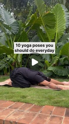 a man laying on the ground in front of some plants and doing yoga poses for everyone to do