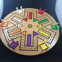 a wooden board game with people playing on it